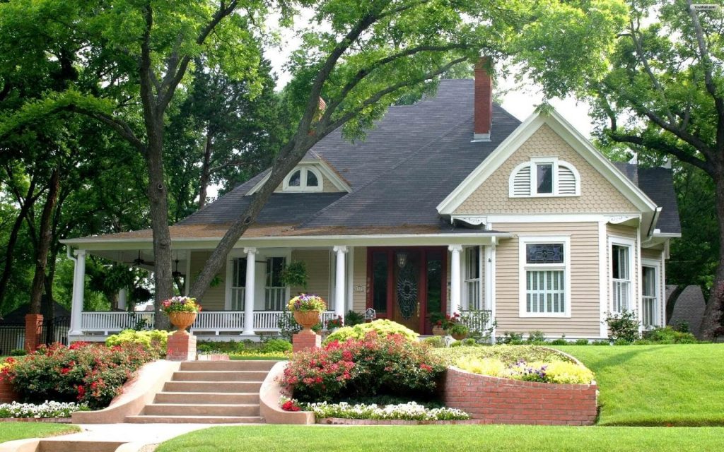 Stunning house design in Nigeria with falling rooftop wide house and stairs and flowers in front walkway