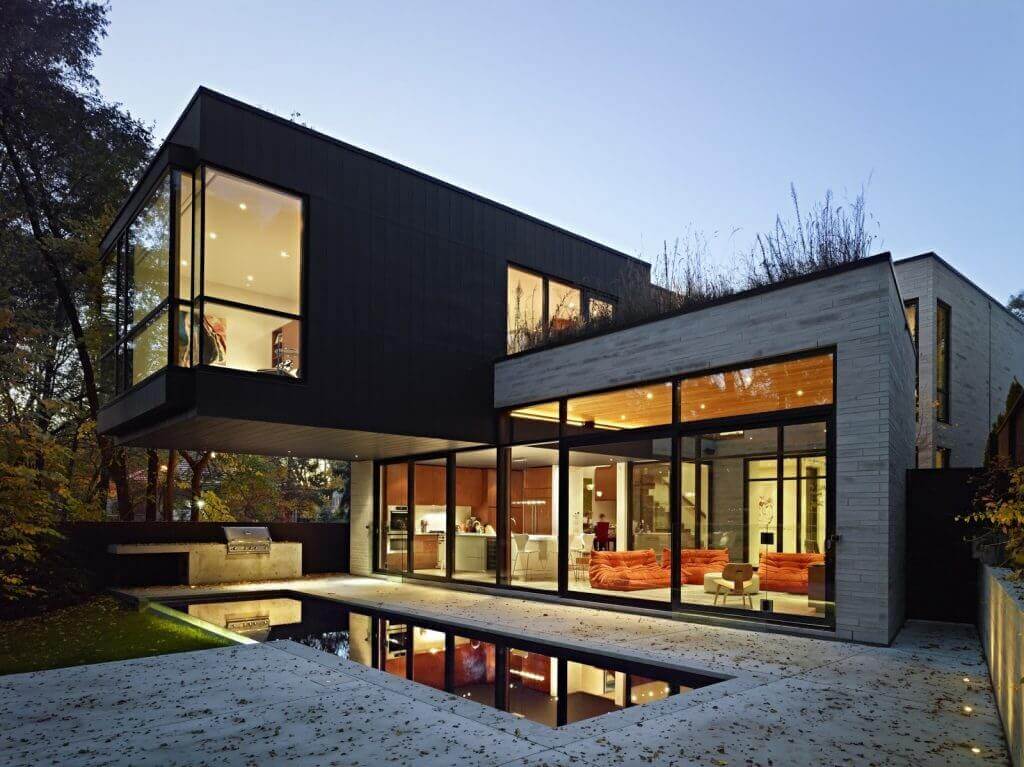 modern Box Style Black and white house Nigeria with small pool in backyard and large glass windows