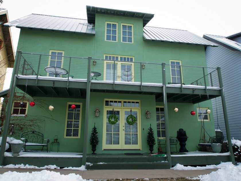 sage green house with Dark Green trim