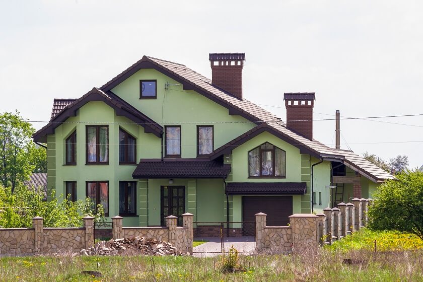 sage green house with black trim and Big chimney Double M Shaped rooftop, a lot of windows