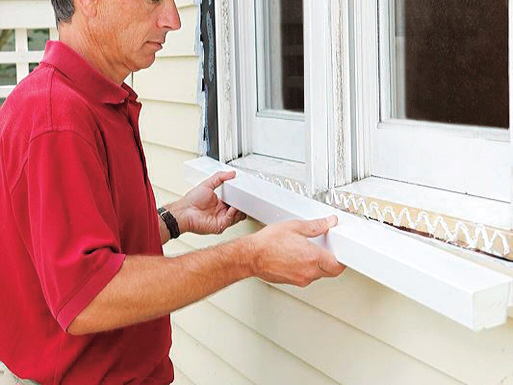 a man fixing a window