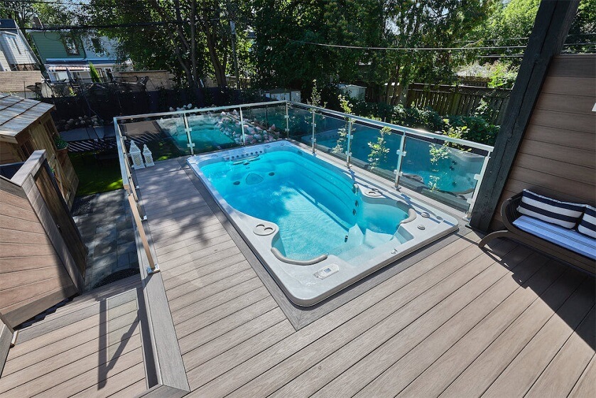 Backyard Deck around a Hot tube pool with Glass Railing