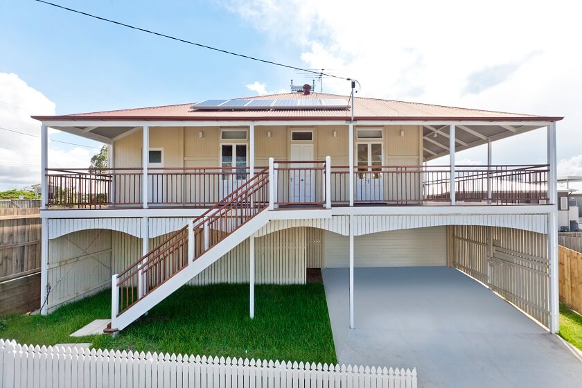 Flat Roof two Storey Queenslander House with stairs In Front