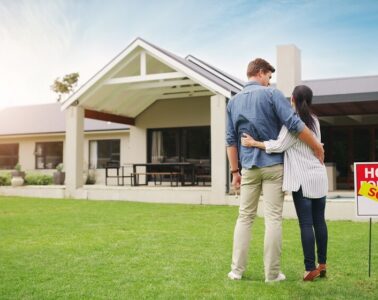 its all ours shot young couple admiring their newly purchased house