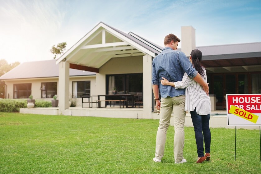 its all ours shot young couple admiring their newly purchased house